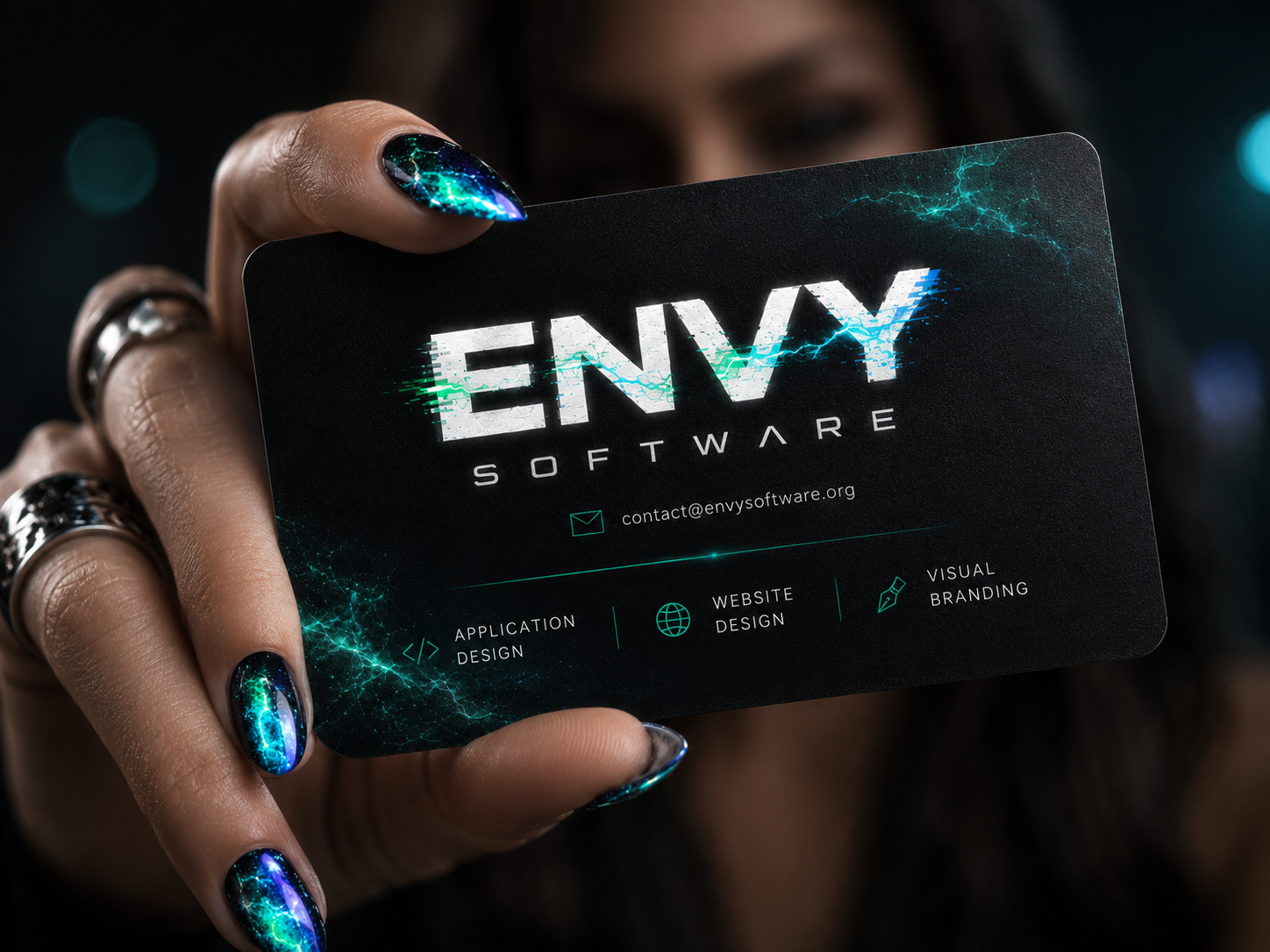 ENVY Software business card with plasma-styled nails and services contact details.